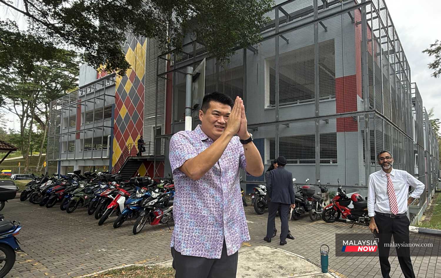 Lawyer N Surendran (right) watches as Albert Tei greets the press outside the Bukit Aman police headquarters, Jan 29, 2026.