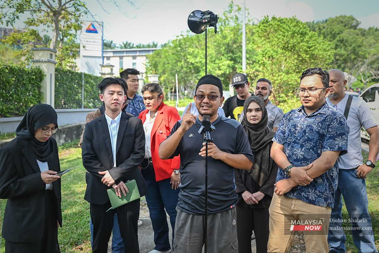 PAS's Zaharudin Muhammad address the press with a loud speaker blaring the speech outside the MCMC headquarters, April 24, 2026.