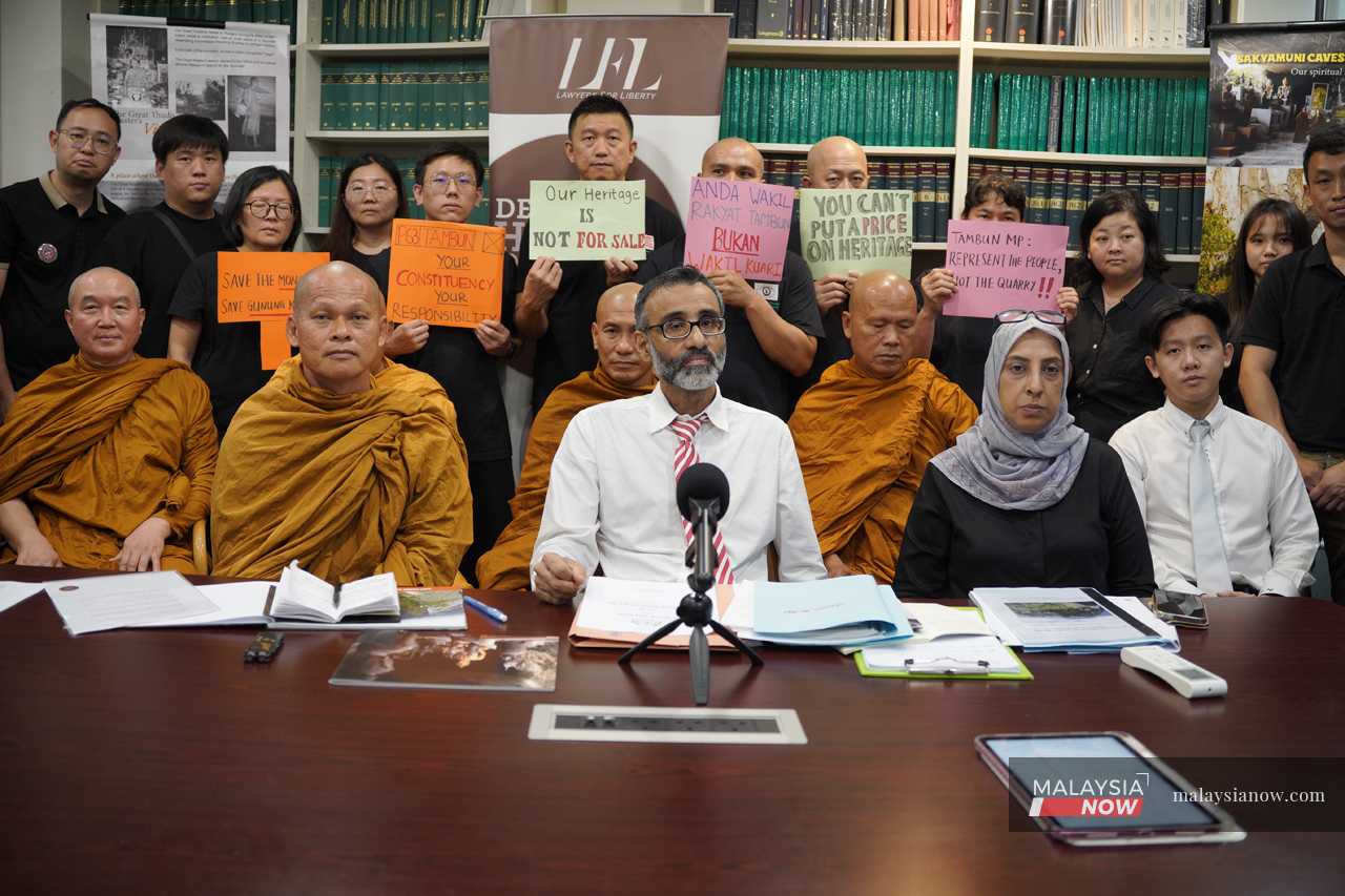 Monks and devotees from the Sakyamuni Caves Monastery during a press conference attended by (seated from left) abbot Bhante Kusala, and lawyers N Surendran and Latheefa Koya.